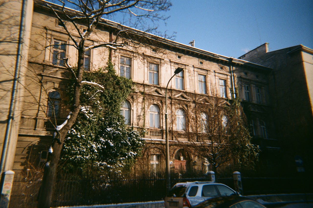 Historical building facade surrounded by winter scenery in Krakow, Poland.